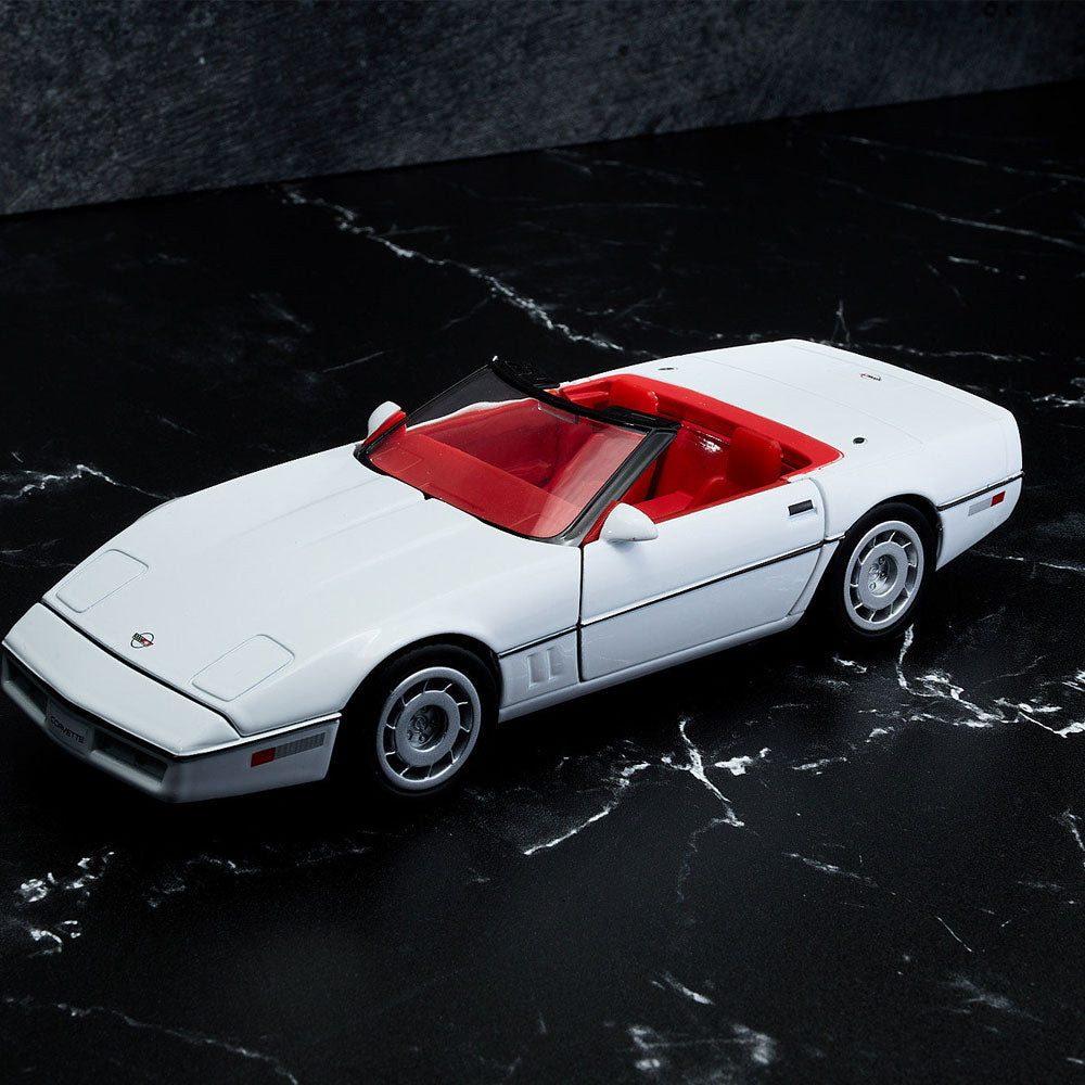 1986 Corvette White Diecast Model sitting on a table 