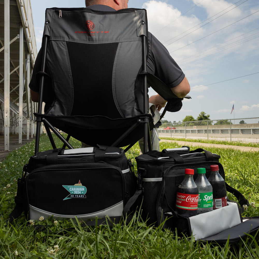 The 2024 NCM Caravan Cooler shown in the grass next to a man sitting in travel chair