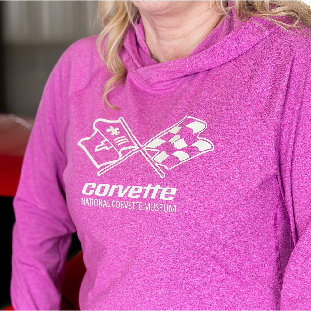 Close up of the C3 Corvette emblem on the front of the Ladies' Adapt Hooded Pullover in Raspberry pink
