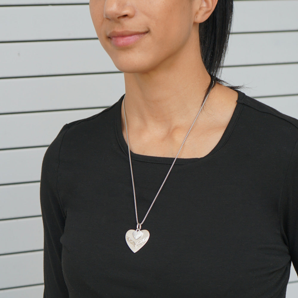 Woman wearing the 7th Generation Corvette Heart with Pave Set Cubic Zirconia Necklace