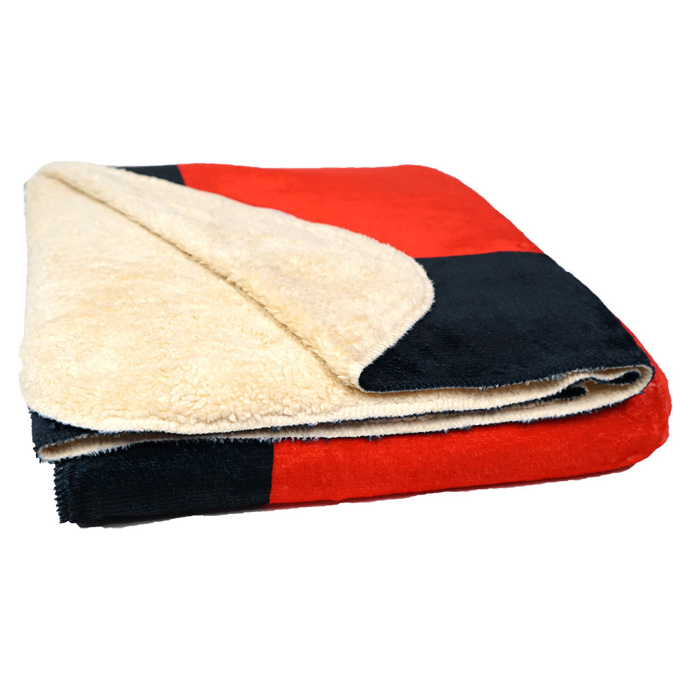 Folded blanket showing the inside faux sherpa material on a white background