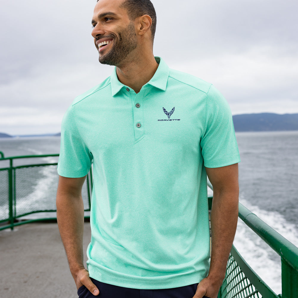 Man standing on a ferry boat wearing a mint green polo with the C8 Corvette emblem embroidered on the left chest.