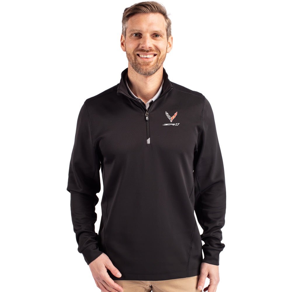 Man wearing a black quarter-zip pullover with an eighth generation Corvette ZR1 logo on a white background