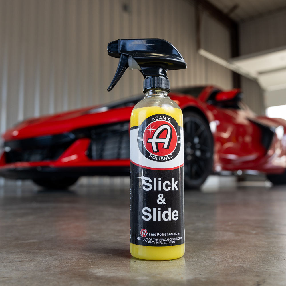 Adams Slick and Slide shown placed on a garage floor in front of a red Corvette