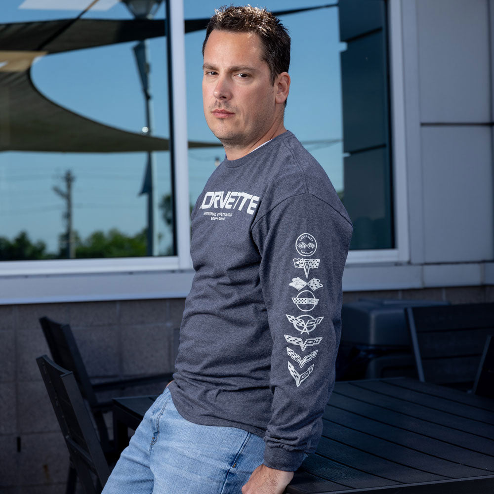 Man wearing the C1-C8 Corvette Emblems Duet Long Sleeve Heather Navy T-shirt