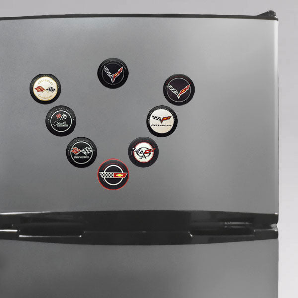 Photo of all eight Corvette emblem magnets on a refrigerator door