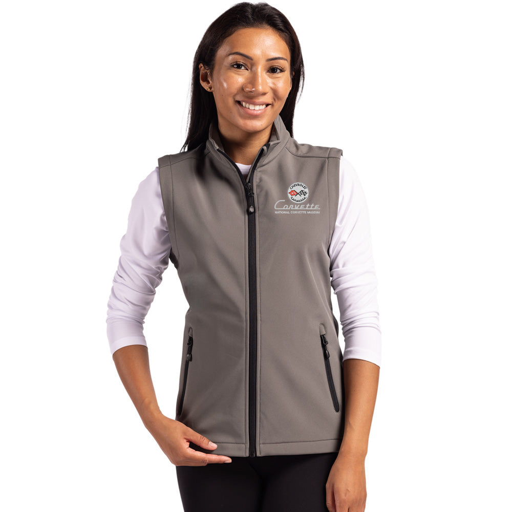Woman wearing a gray vest with a C1 Corvette logo on a white background