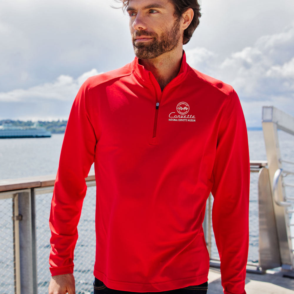 Man standing on a dock wearing the C1 Corvette Custom Virtue Eco Red Quarter Zip 