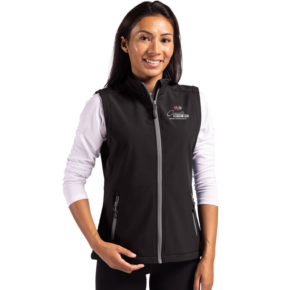 Woman wearing a black vest with the C2 Corvette emblem on a white background