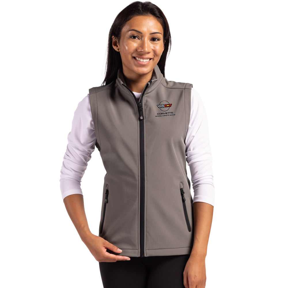 Woman wearing a gray vest with a C4 Corvette emblem on a white background
