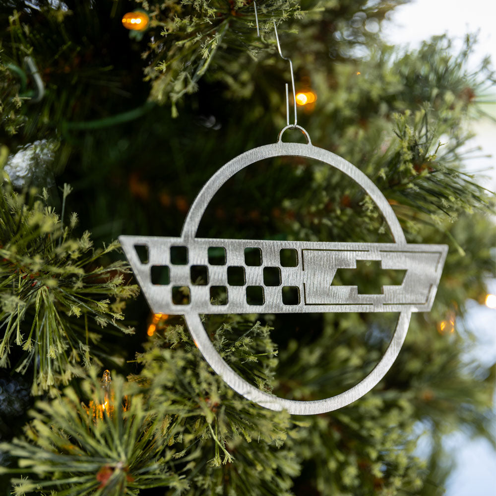 C4 Corvette Emblem Ornament shown hanging on a tree