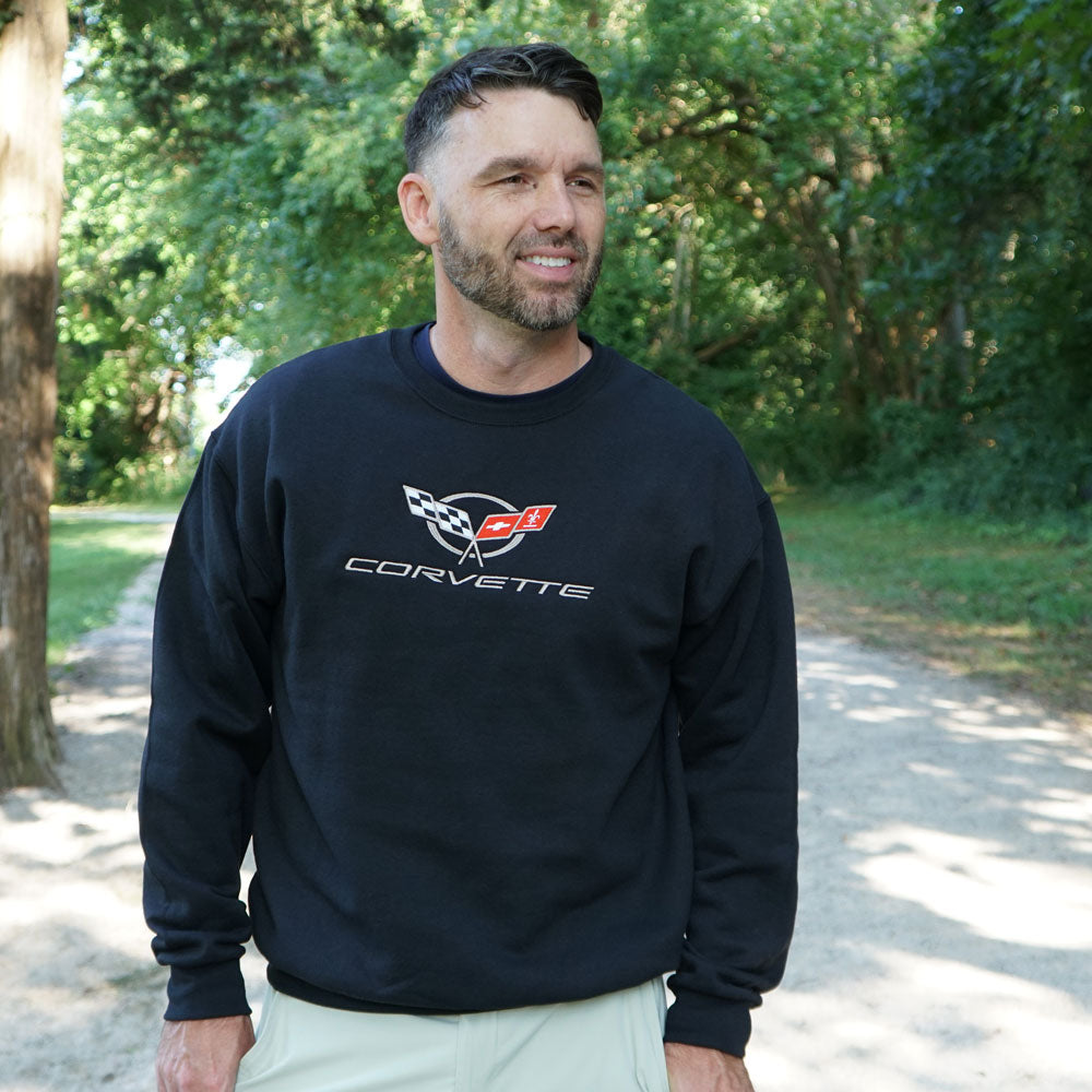 Man walking in a park wearing the C5 Corvette Embroidered Emblem Classic Black Sweatshirt