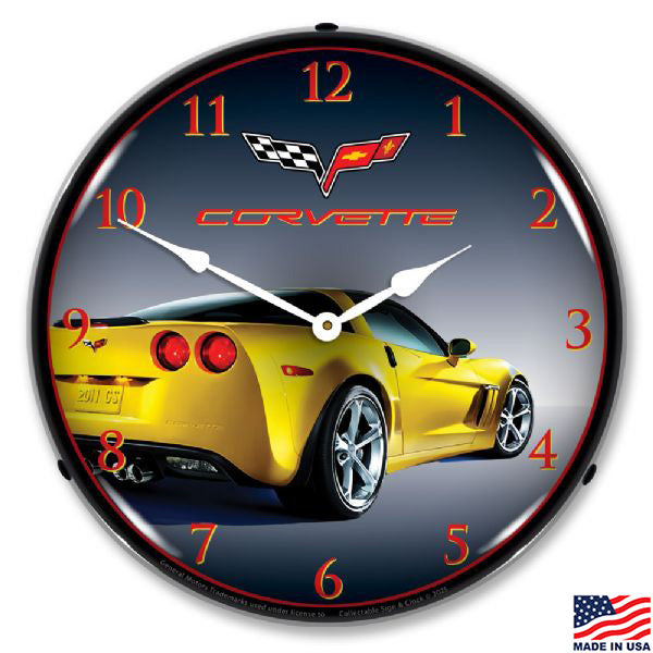 Corvette clock with a yellow c6 car design on a dark background