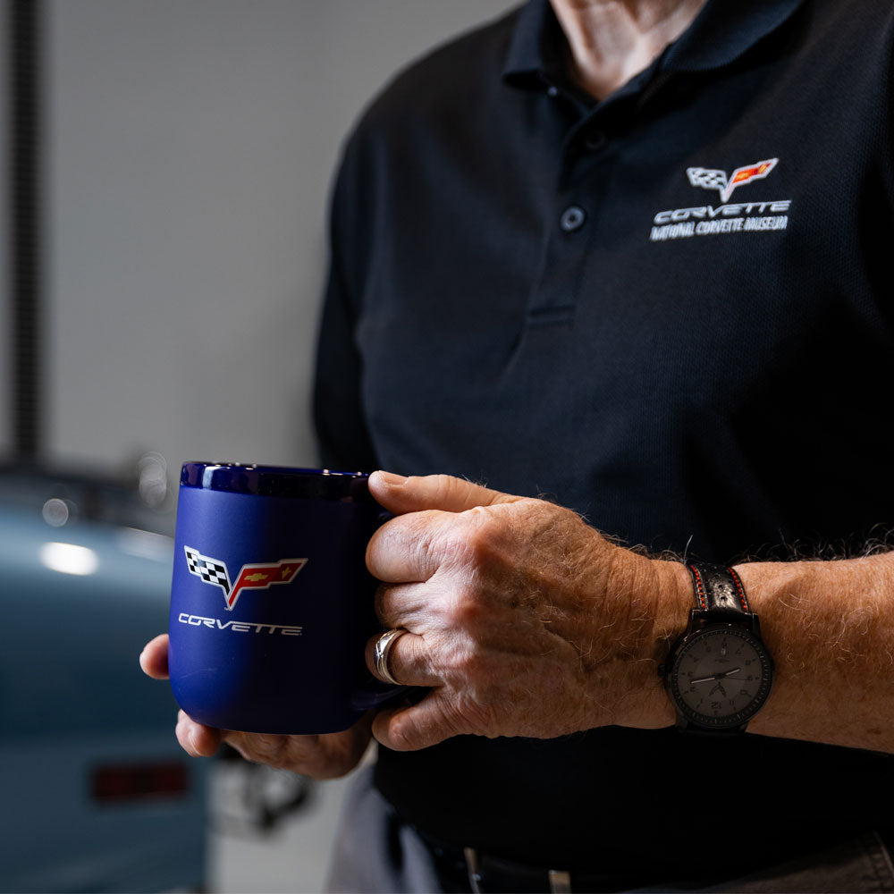 Man wearing a C6 Corvette polo and holding the C6 Corvette Modelo Cobalt Coffee Mug