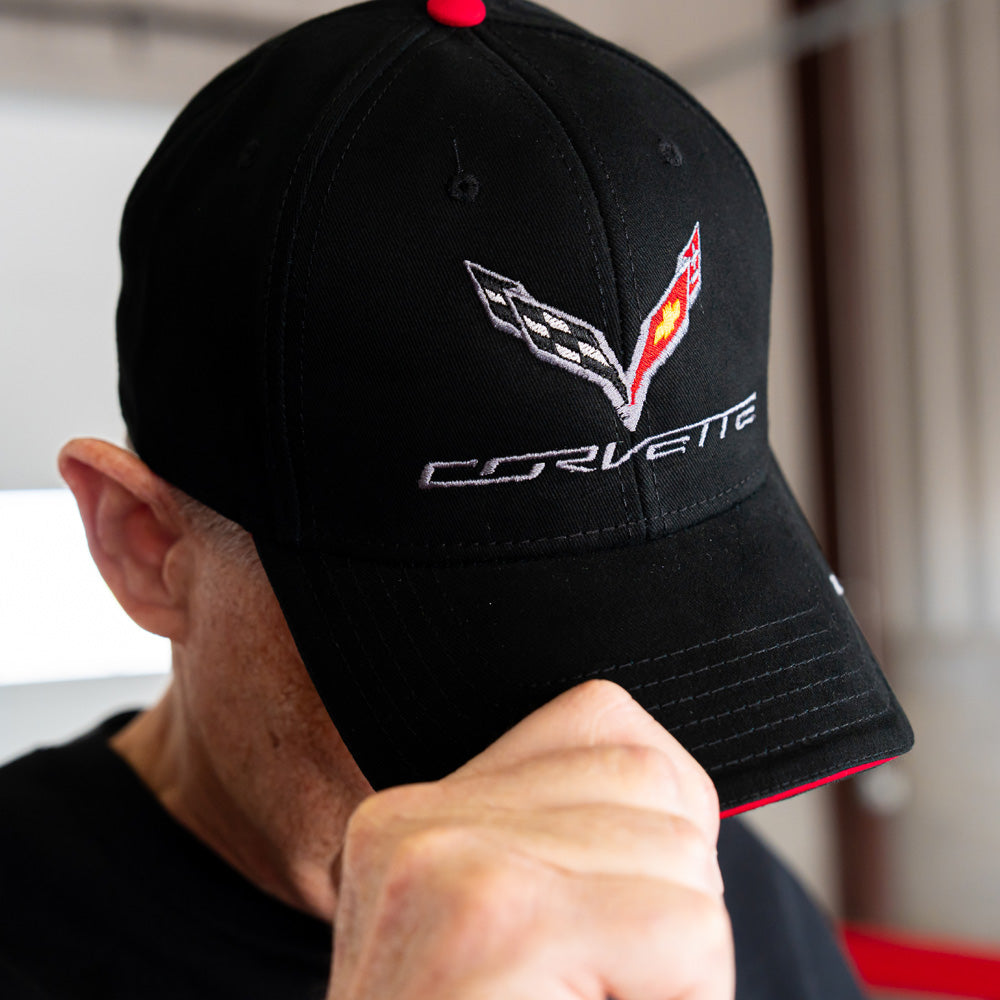 Person wearing a black Corvette cap with a C7 Corvette logo