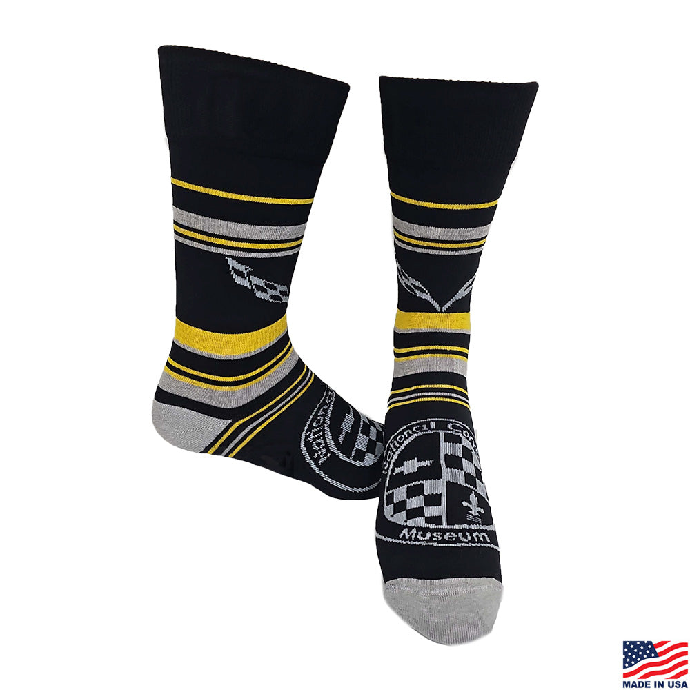 Black socks with yellow and gray stripes that feature the C7 Corvette emblem shown on a white background
