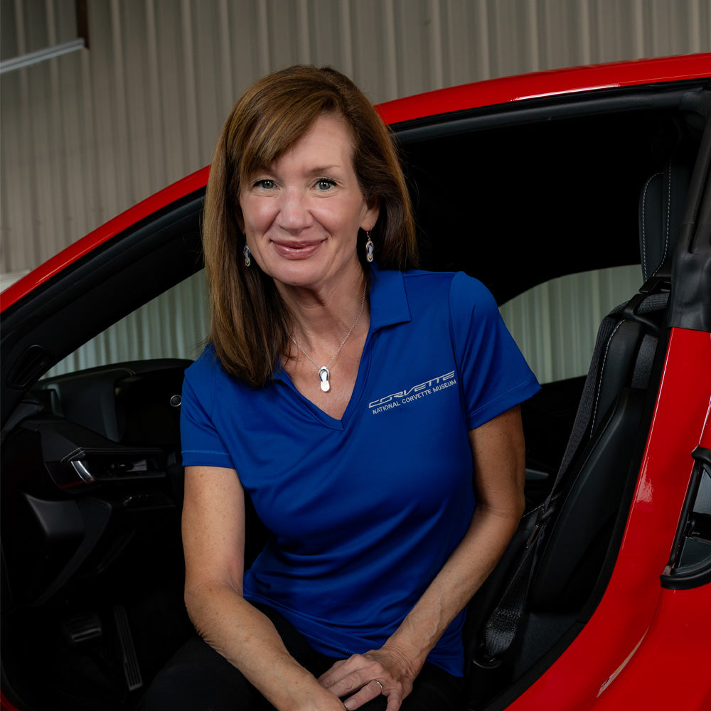 Woman wearing the C7 Corvette Script Royal Blue Daybreak Polo 