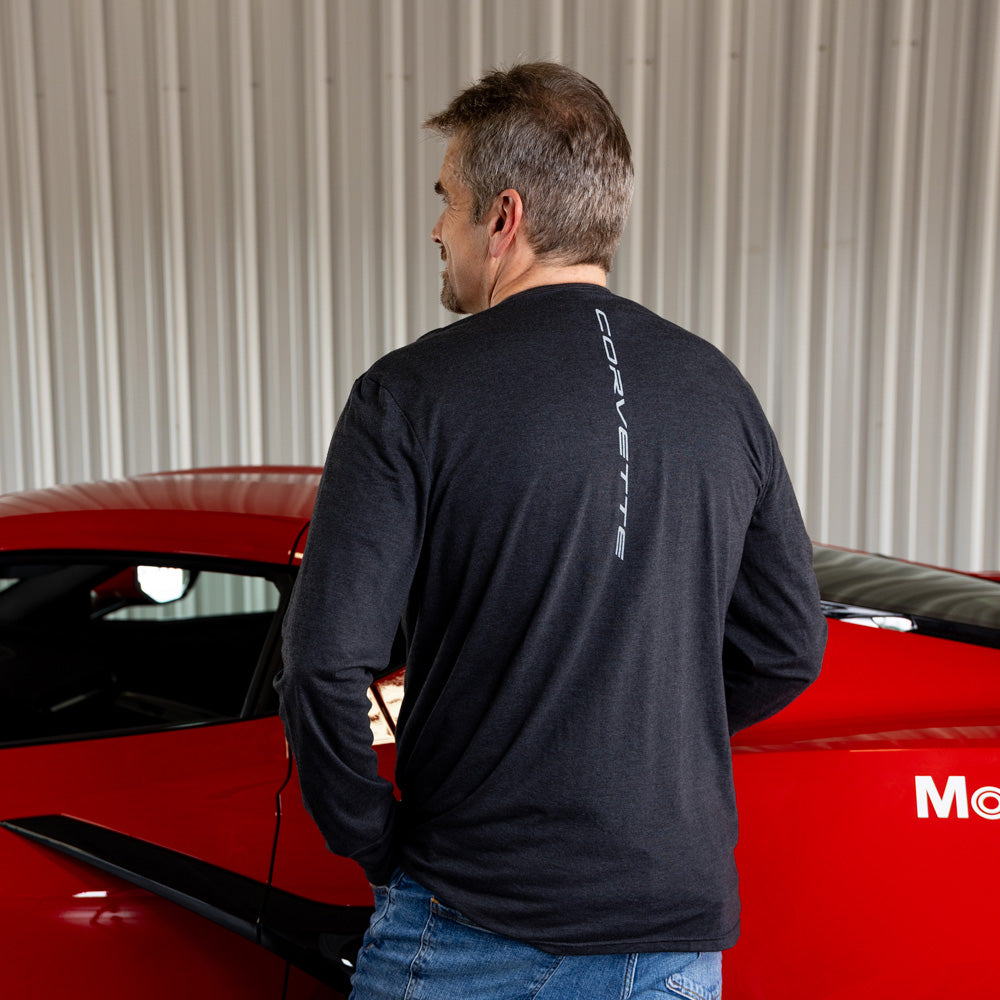 Man wearing a heather black long sleeve t-shirt with Corvette script running vertically down the back.
