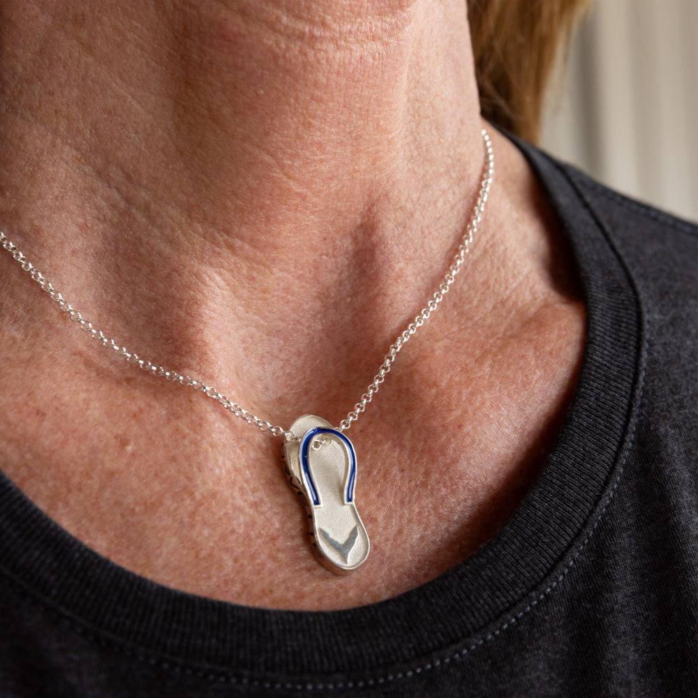 Woman wearing the sterling silver C8 Corvette flip flop pendant on a necklace.