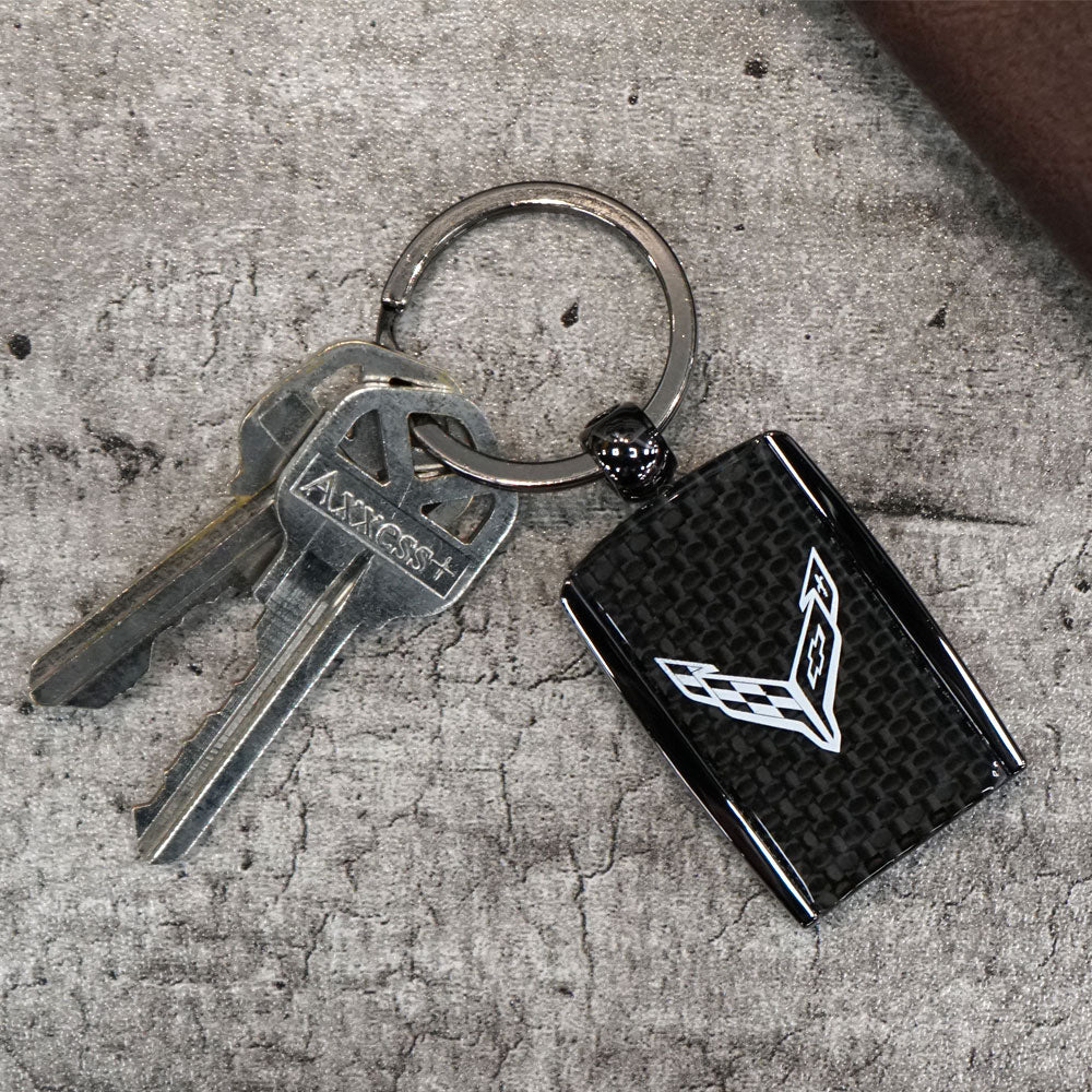 The C8 Corvette Carbon Fiber Style Keychain displayed on a table