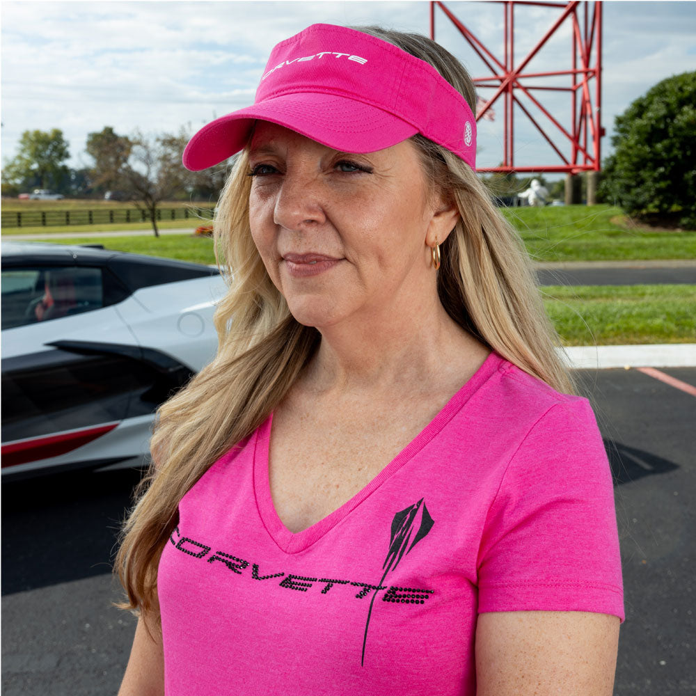 Woman standing in front of a Corvette wearing the C8 Corvette Crystal Stingray Fuchsia Ladies Top