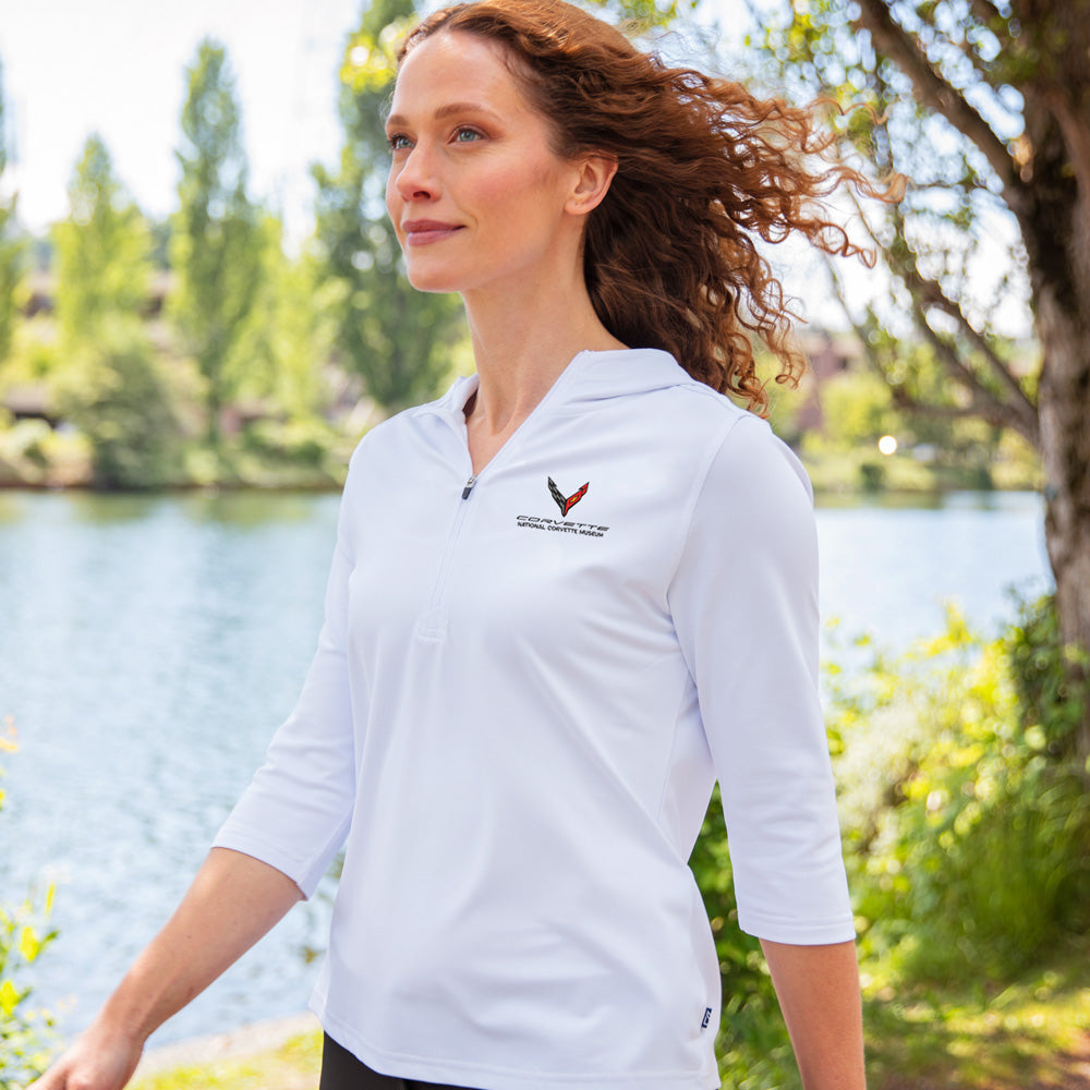 Woman walking by a lake wearing the White C8 Corvette Custom Virtue Eco  Quarter Zip Pullover