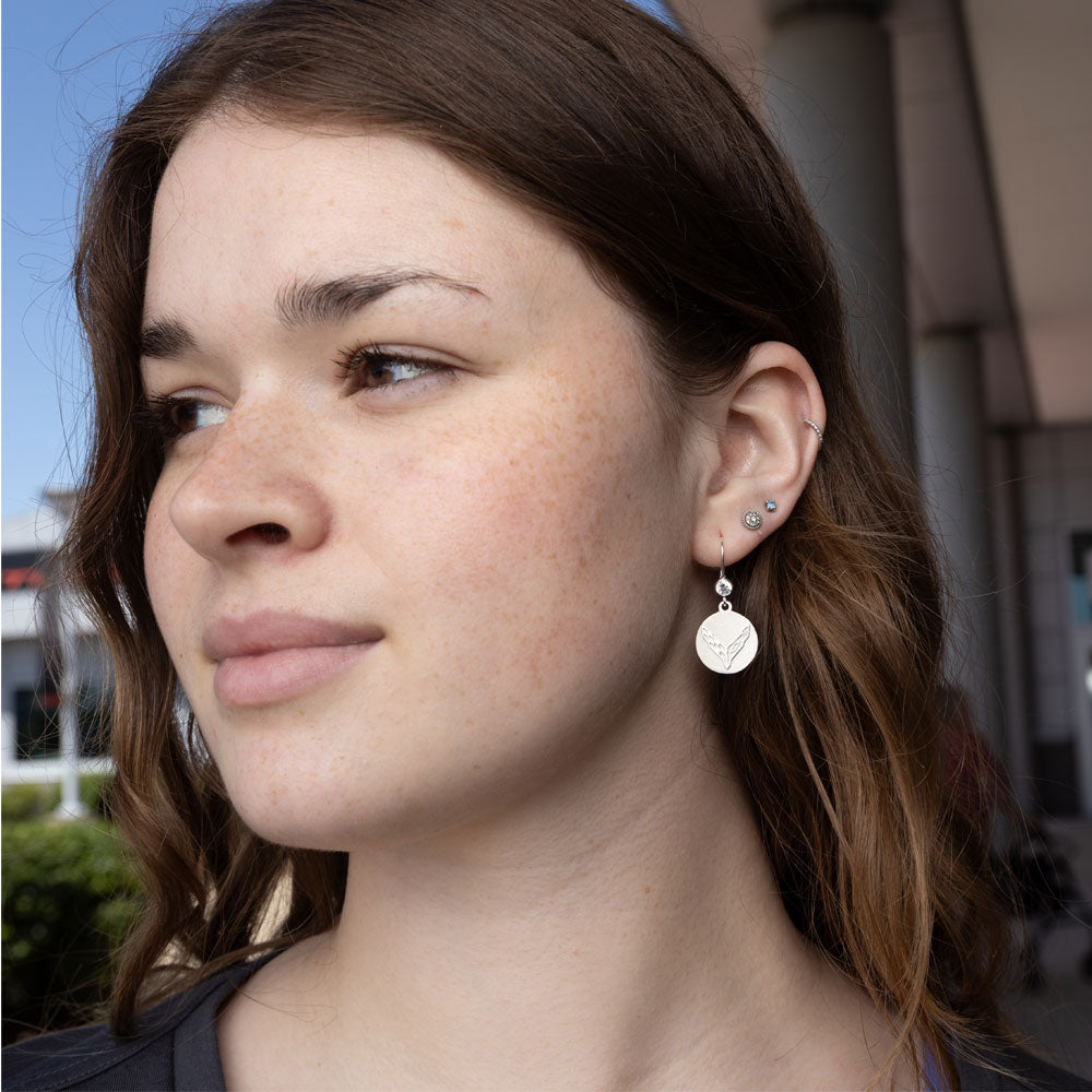 Woman wearing the C8 Corvette Emblem CZ Earrings