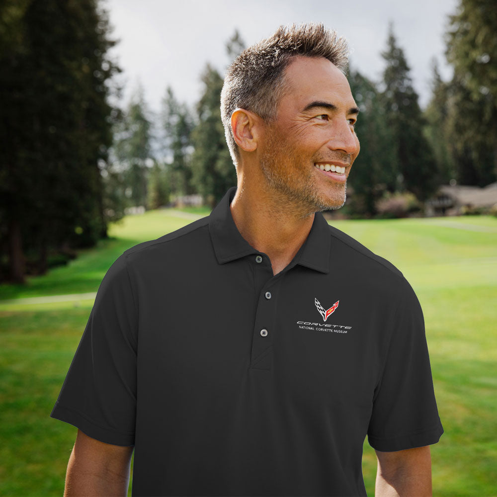 Man wearing the C8 Corvette Emblem Core Virtue Polo while out on the golf course