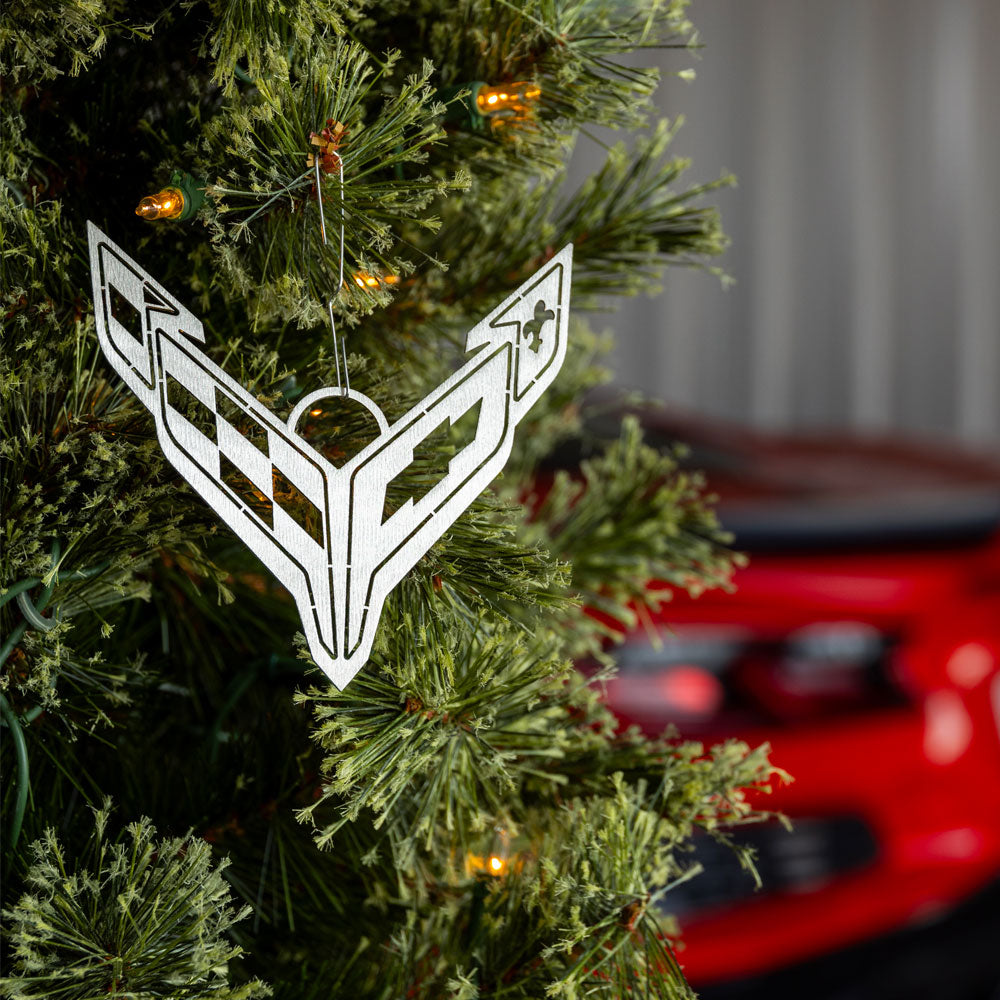 C8 Corvette Emblem Ornament shown hanging on a tree