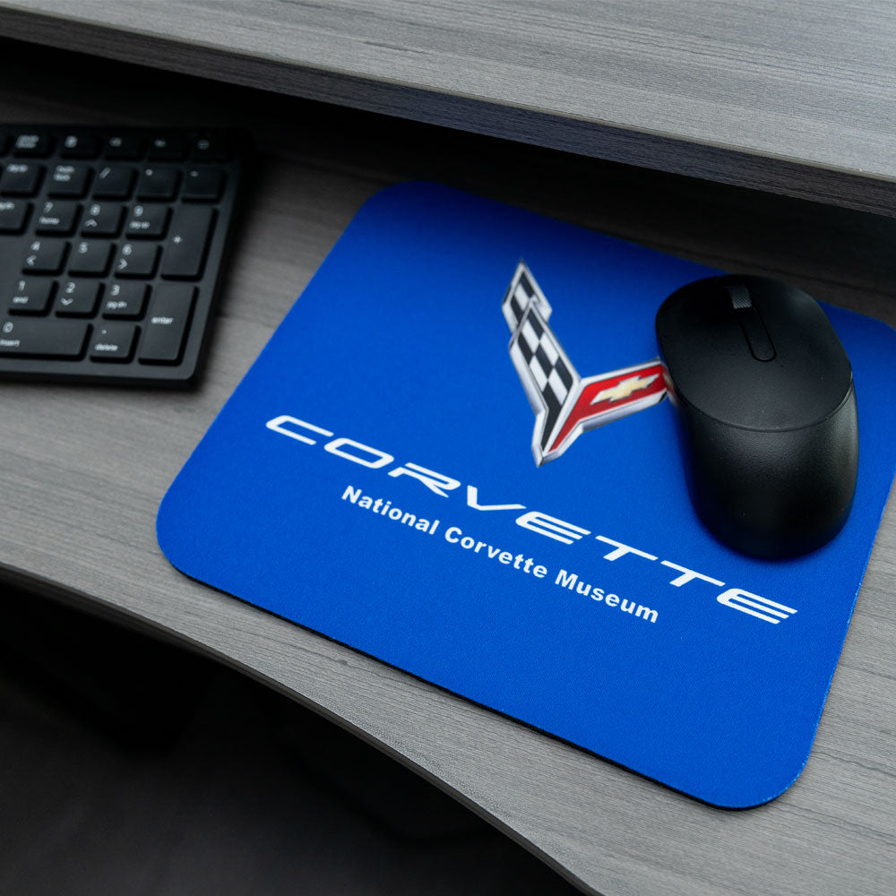 C8 Corvette Emblem Royal Blue Mouse Pad shown placed on a desk next to a keyoard