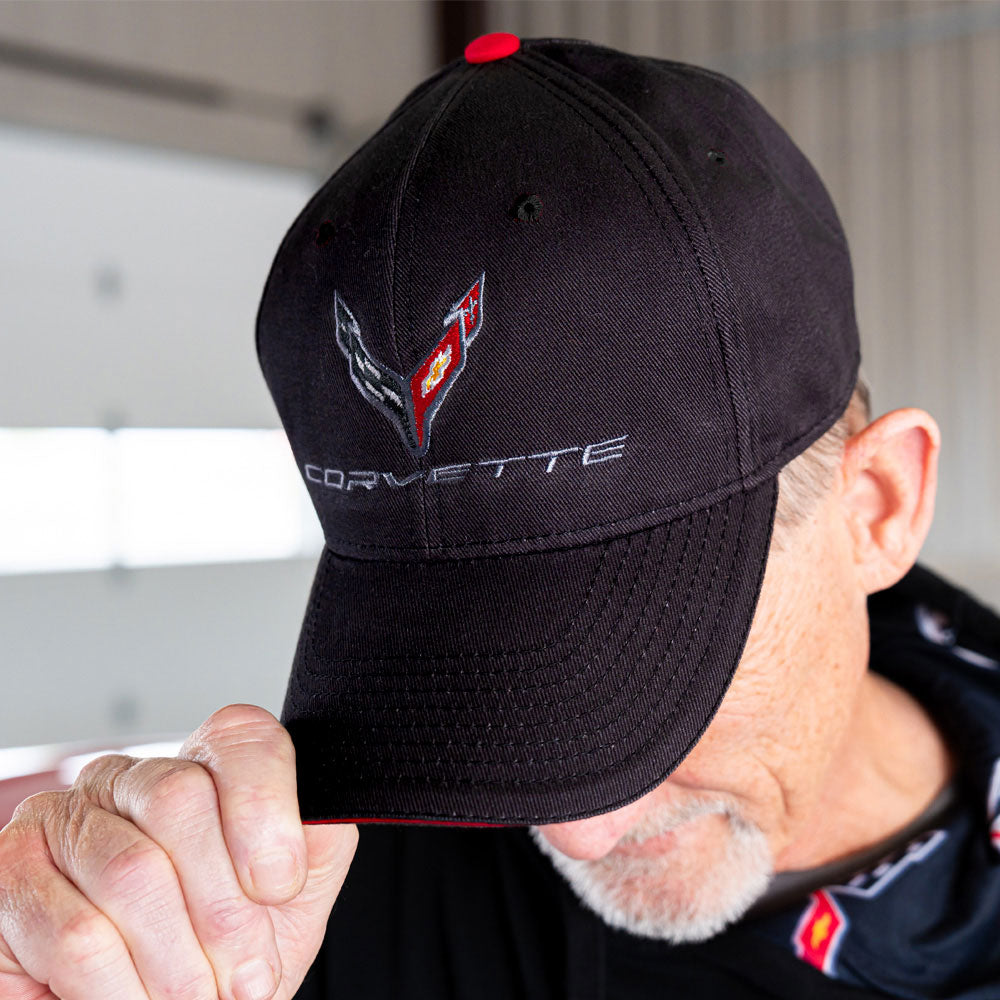 Man standing in a garage wearing the C8 Corvette Emblem Sandwich Cap.