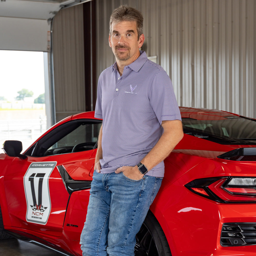 Man wearing the C8 Corvette Forge Double Stripe Purple and White Polo 