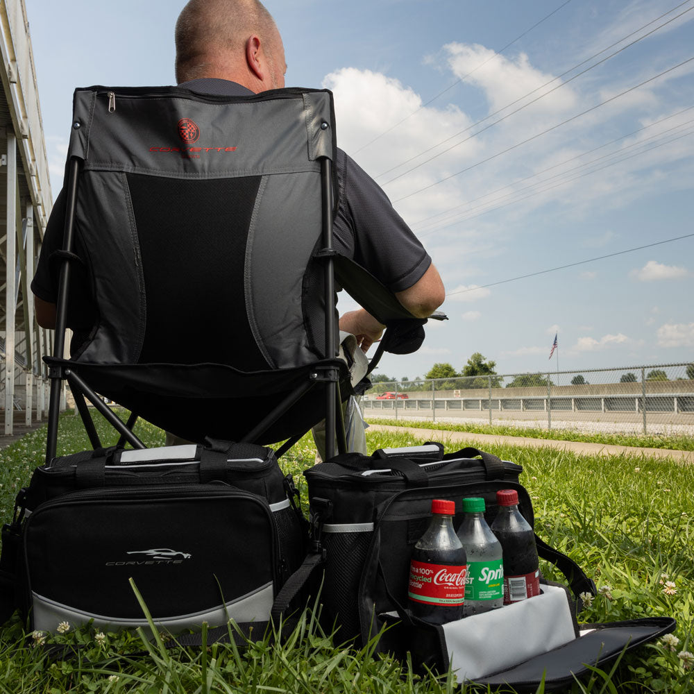 The C8 Corvette Gesture Black Cooler shown placed next to a travel chair in the grass
