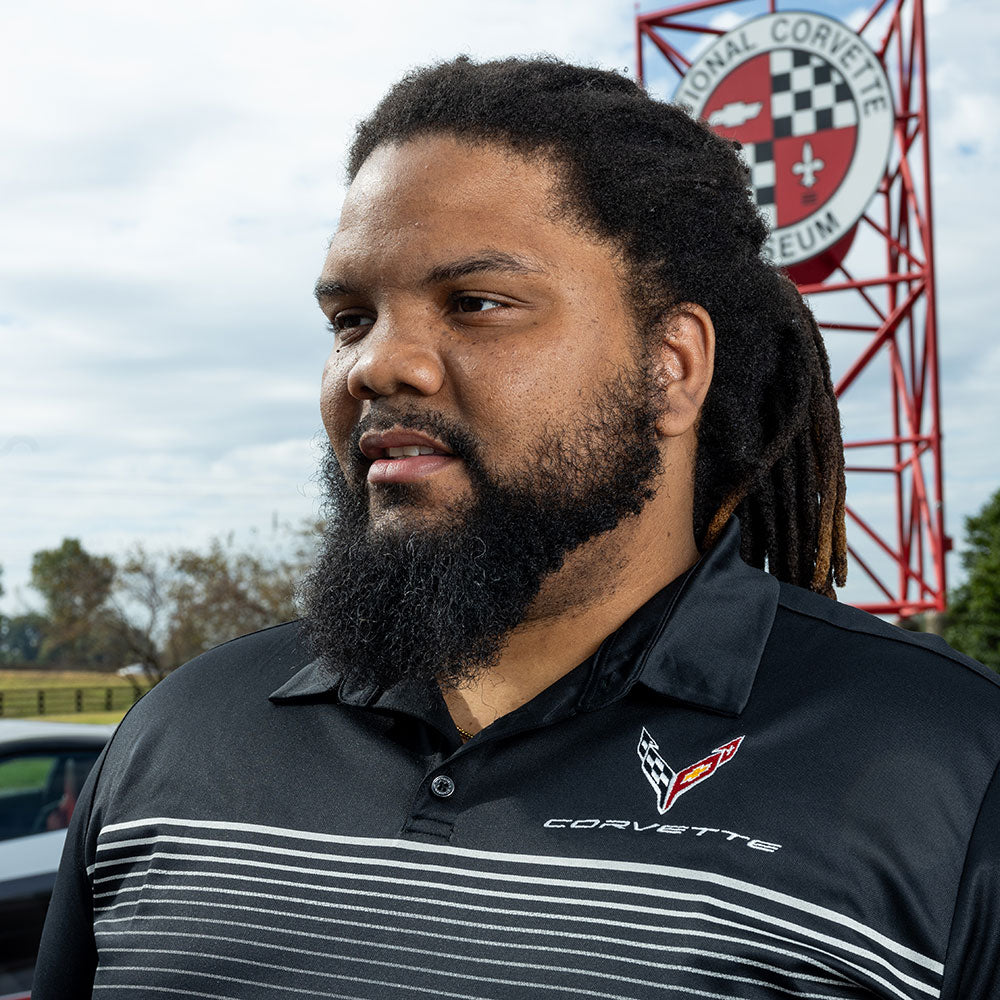 Man wearing the Black C8 Corvette Gesture Striped Polo