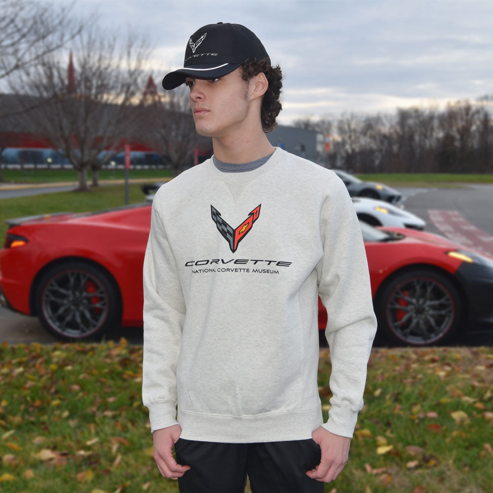 Man standing in front of a red Corvette wearing the C8 Corvette Heavyweight Crew Sweatshirt