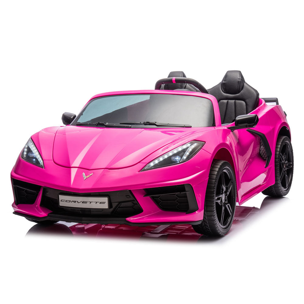 A bright pink Corvette convertible toy car with black seats, black wheels, and a black front grille, photographed on a clean white studio background.