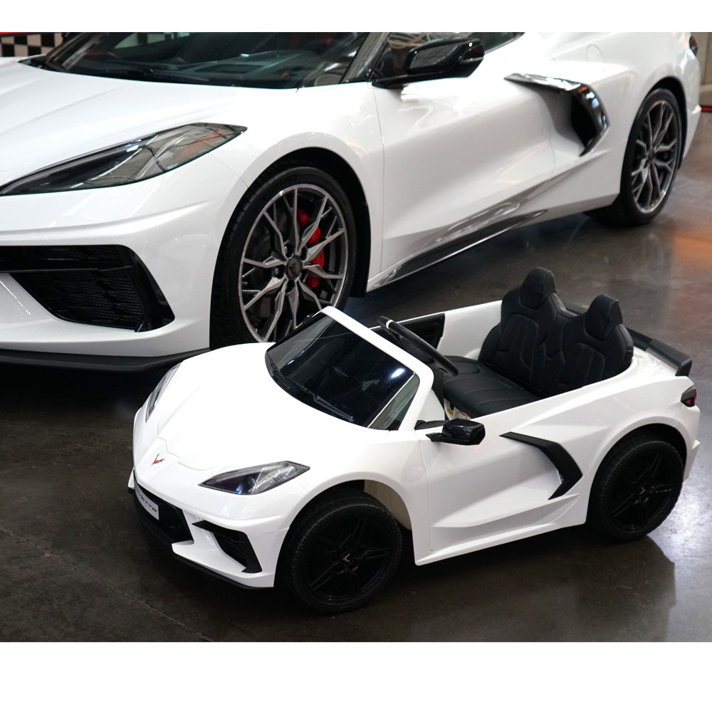 The C8 Corvette Kids 24 Volt Electric White Ride On Car parked next to a full size C8 White Corvette