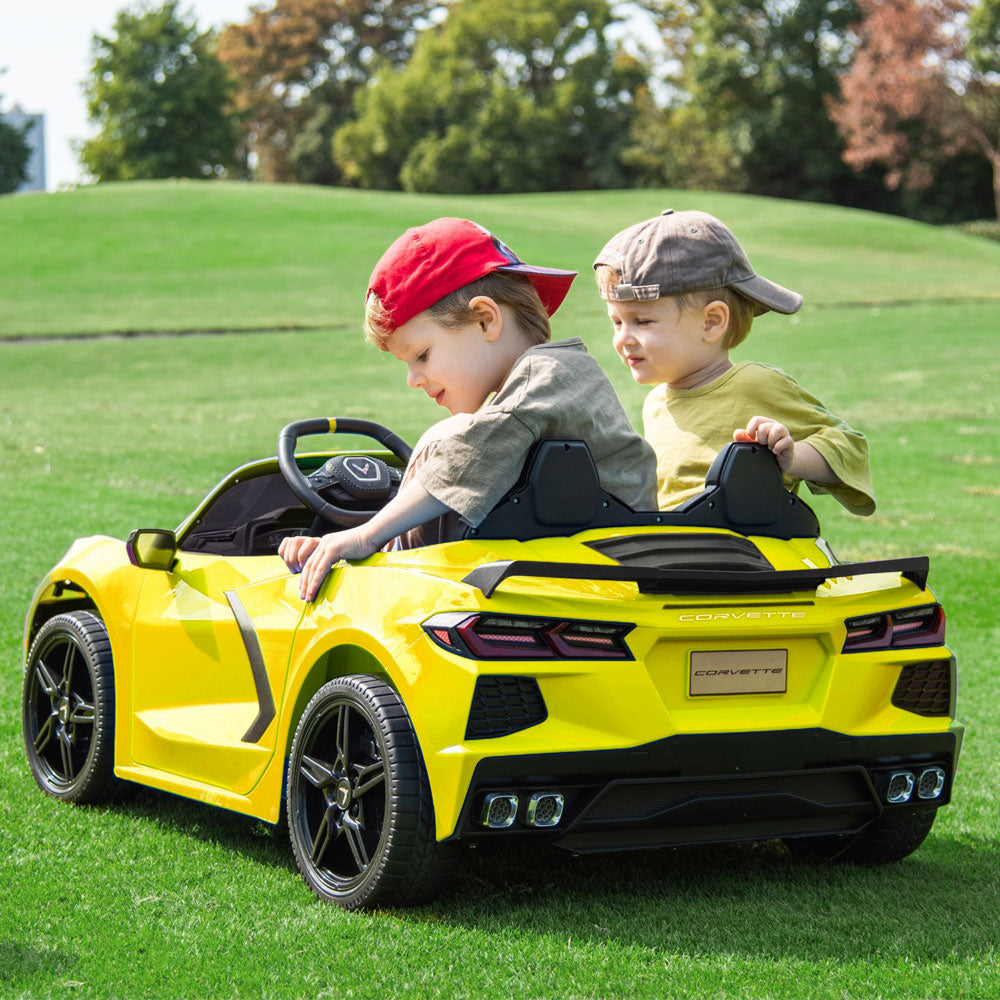 Two kids riding in the C8 Corvette Kids 24 Volt Electric Yellow Ride On Car
