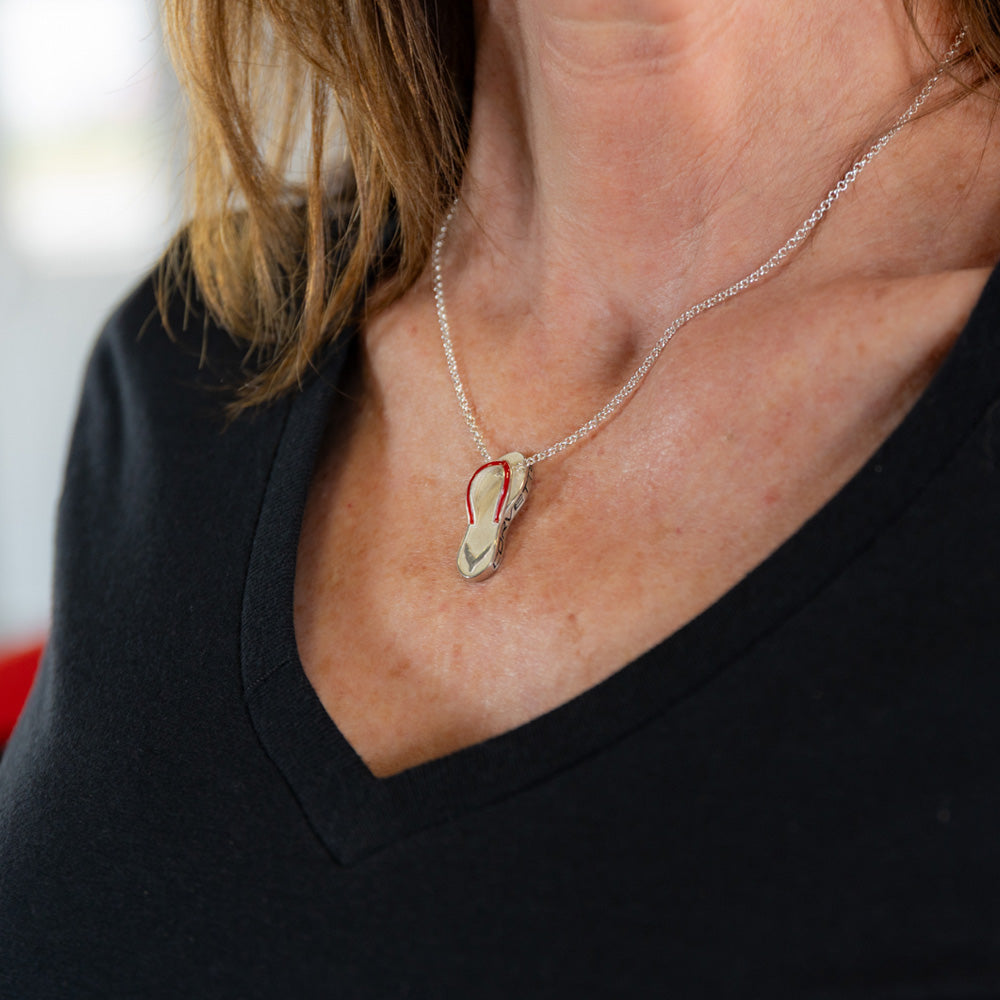 Woman wearing the C8 Corvette Red Flip Flop Pendant on a necklace.