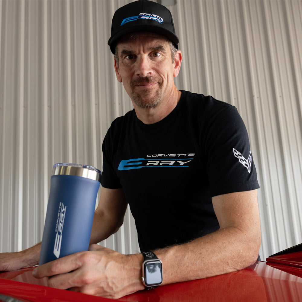 Man wearing a black Corvette E-Ray t-shirt holding a blue tumbler.