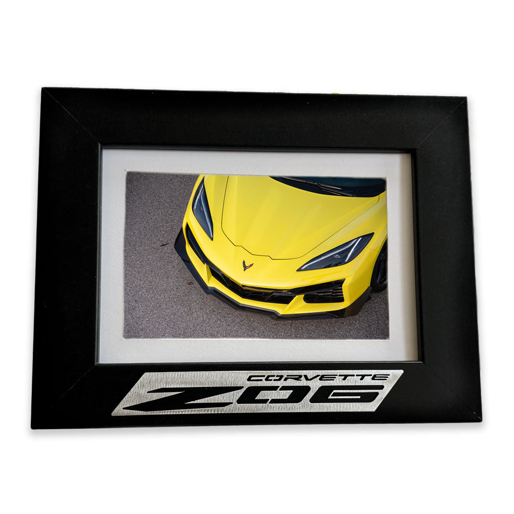 C8 Z06 Corvette Emblem Picture Frame shown with a yellow C8 Z06 Corvette photo