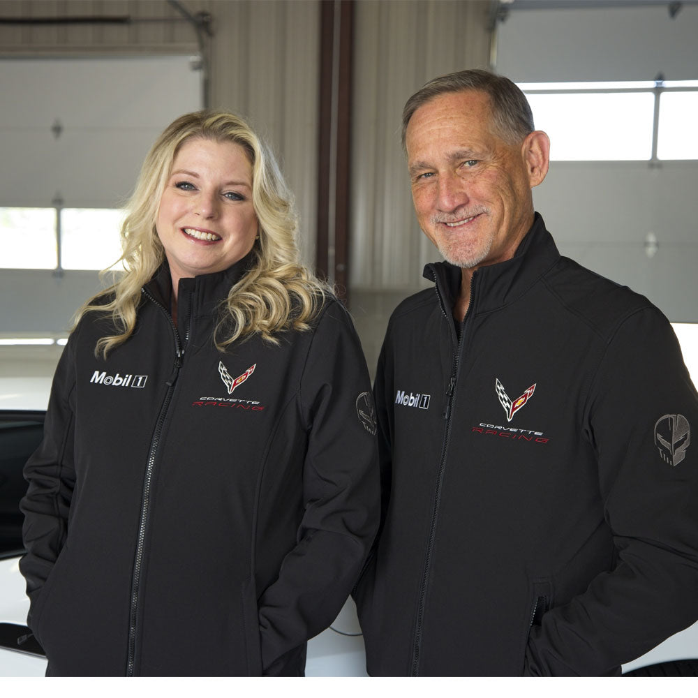 A couple wearing matching C8R Corvette Racing Mobil 1 black jackets