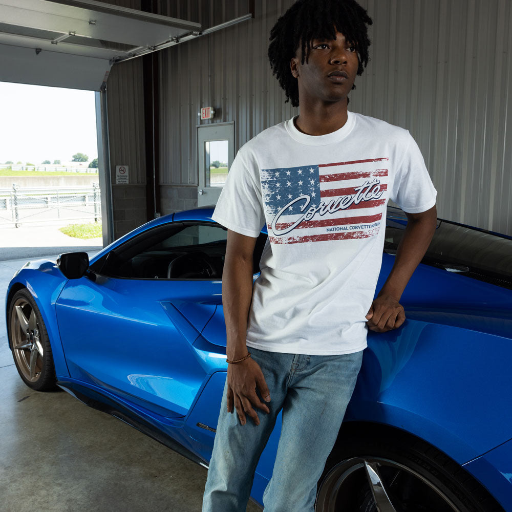Man standing next to a blue Corvette wearing the Corvette American Flag White T-shirt 