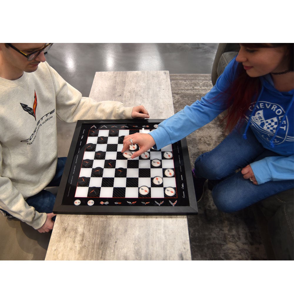 Two people playing with the Corvette Checkerboard game