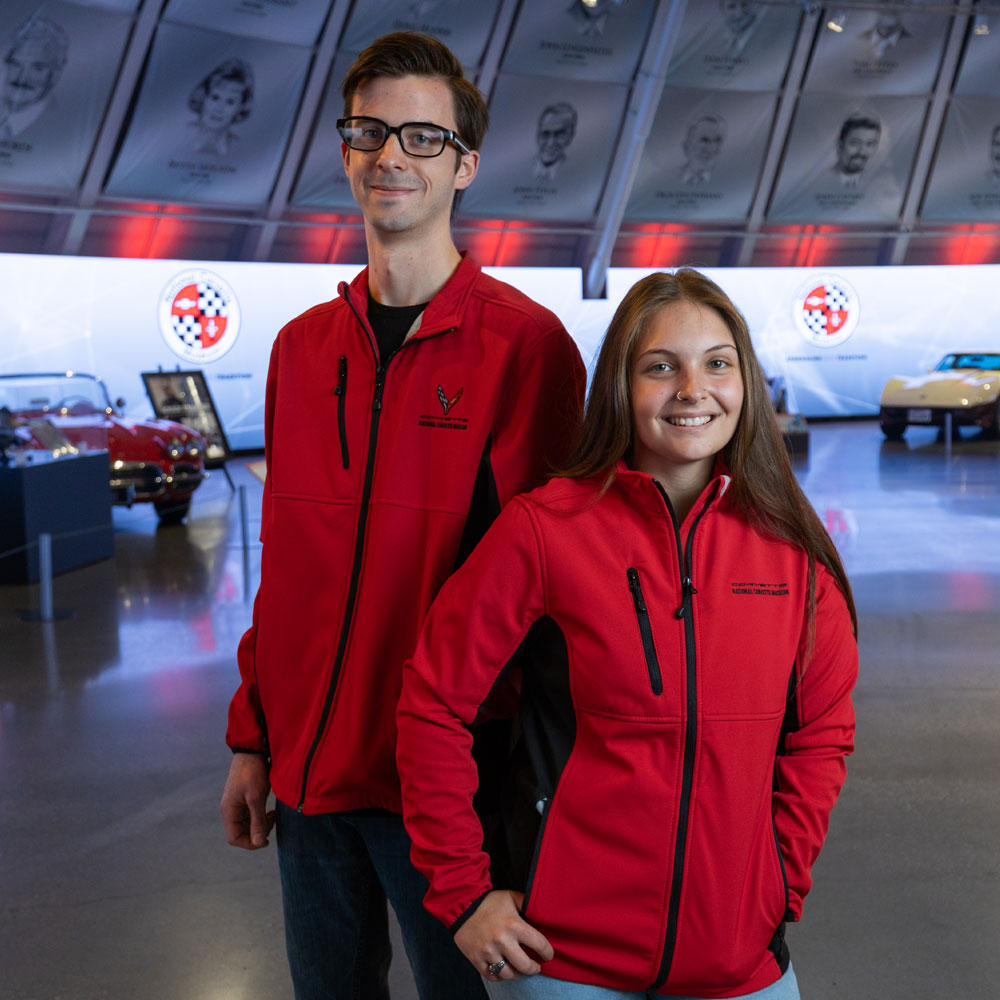 A man and woman wearing matching red and black Corvette jackets