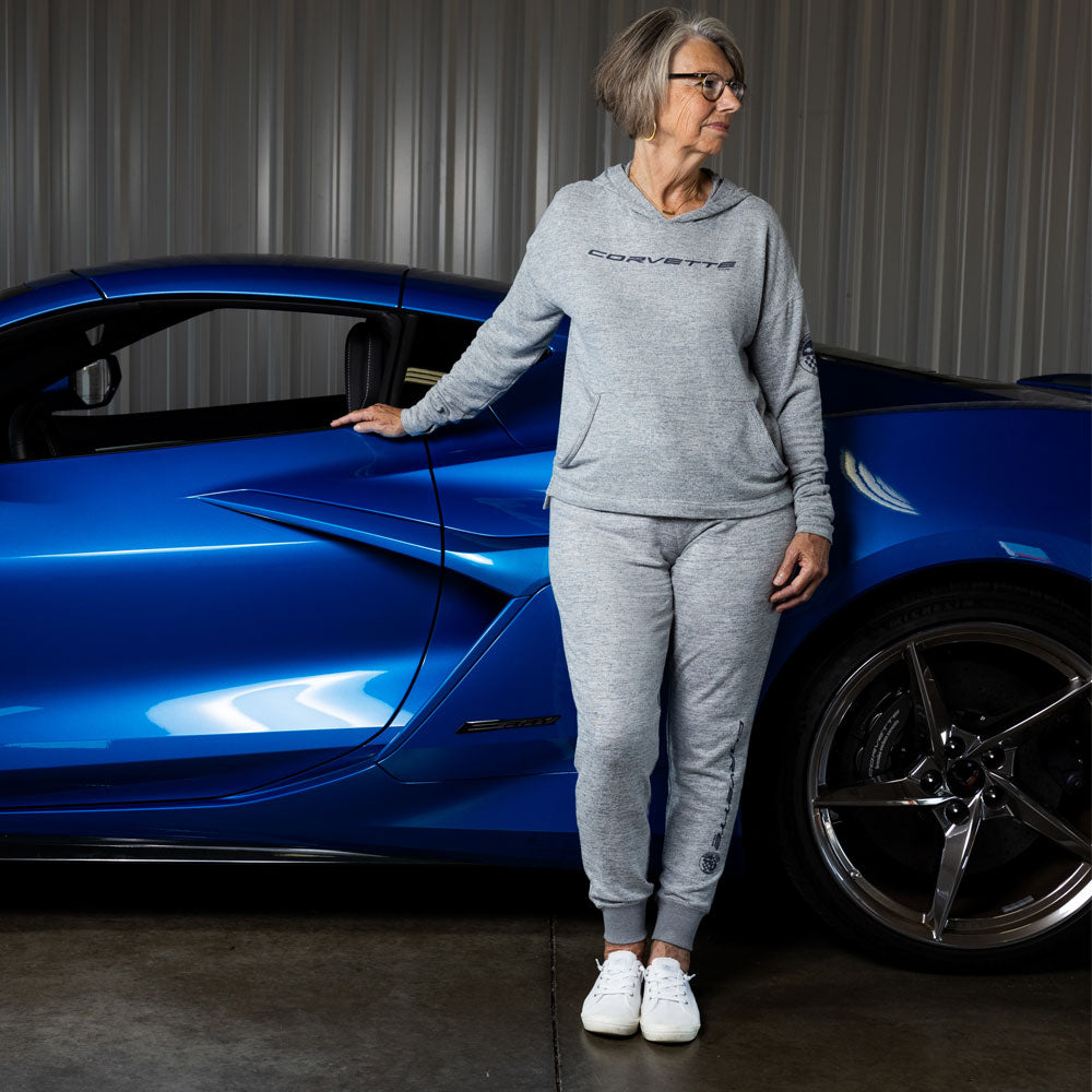 Woman leaning on a blue Corvette wearing the Corvette Ladies Navy Lounge Jogger Pants