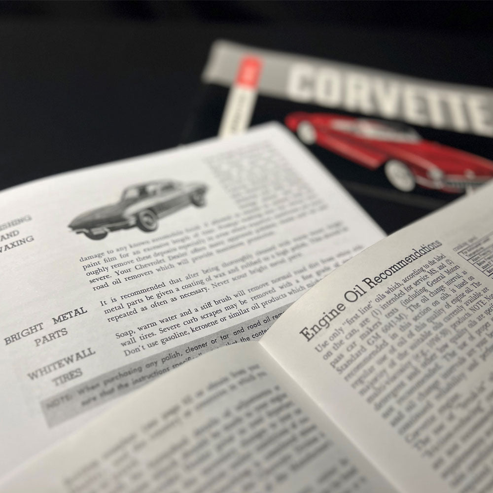 Corvette Owners Manuals Assorted Years Laying on a table