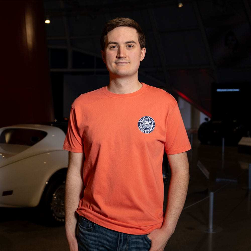 Man wearing the Corvette Retro Circle Coral T-shirt showing the design on the front