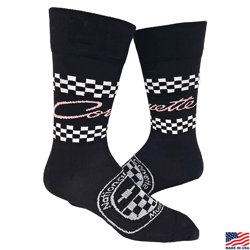 Black socks with checkered patterns and Pink Corvette script shown on a white background