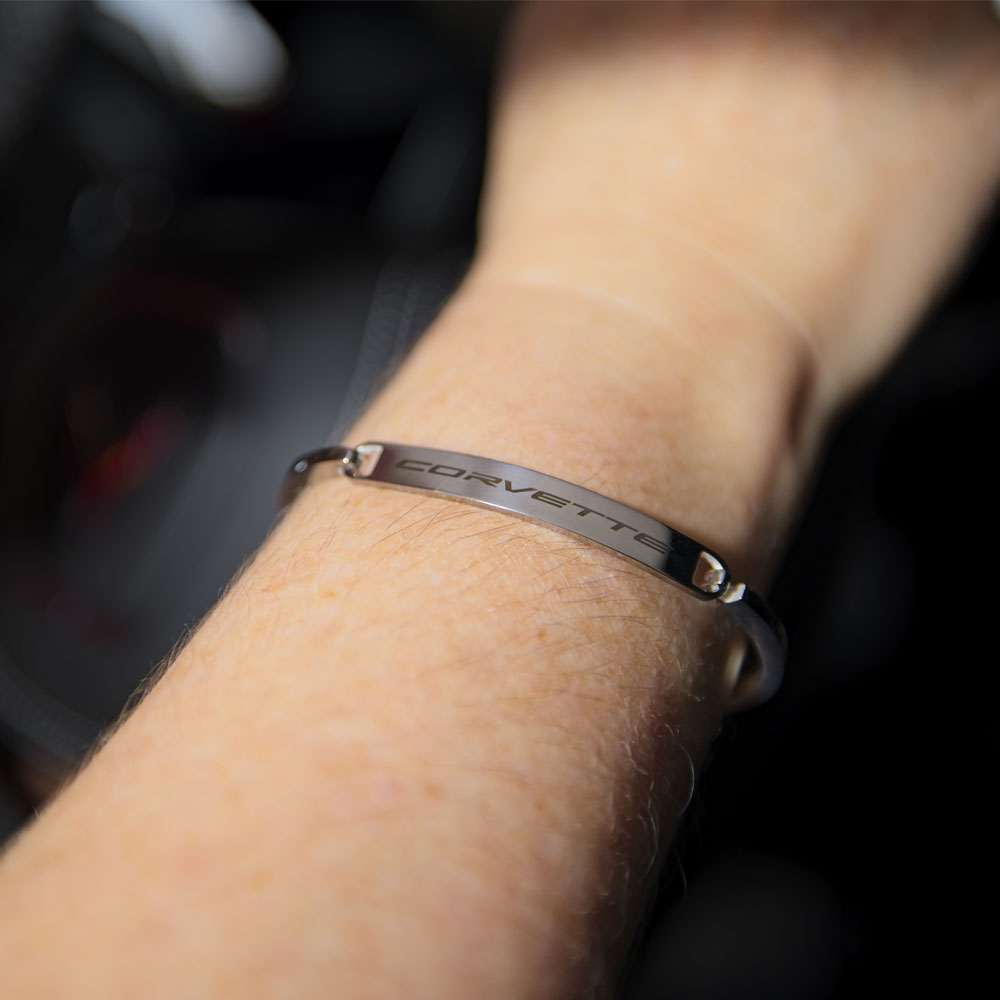 Woman wearing the Corvette Script Stainless Steel Bangle Bracelet.